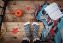 pair of feet with pumpkin and a book