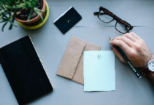 letter with a hand and glasses