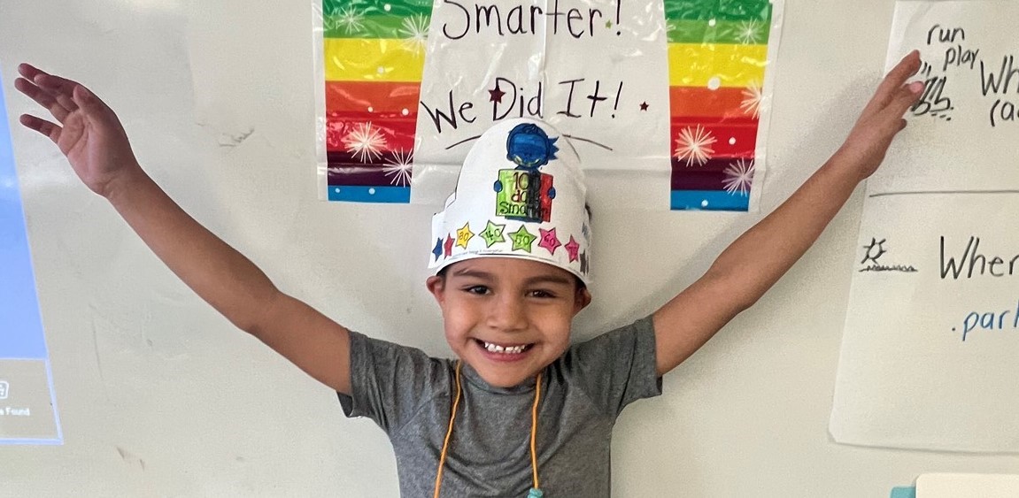 student in front of white board