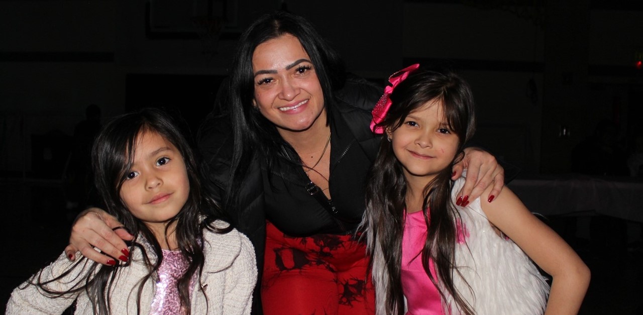 parent and two students at a dance