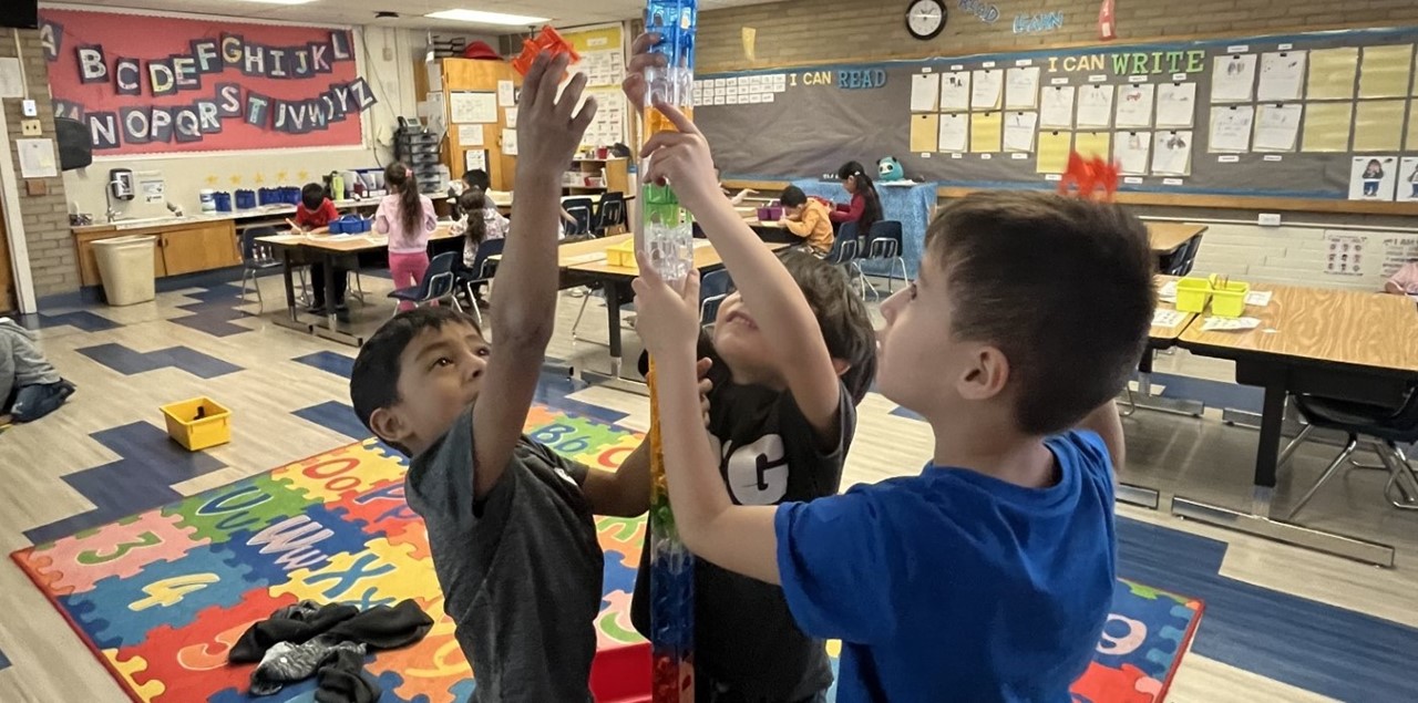 group of boys in class building a tower