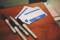 Name Tags on a desk with some pens